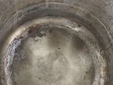 a metal bowl that has a lot of dirt in it
