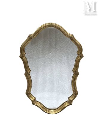 a close up of a gold mirror on a white background
