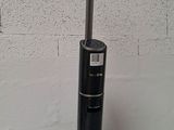 a vacuum that is sitting on a table in front of a brick wall
