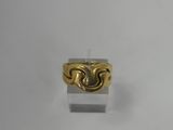a close up of a gold ring on a white surface