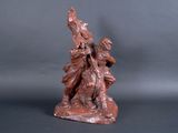 statue of a woman with a bird on her shoulder and a man on a horse