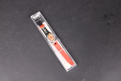 a red toothbrush sitting on top of a black table