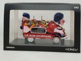 figurine of a man driving a car with a bunch of teddy bears in the back