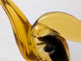a glass sculpture of a bird with a yellow beak