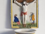 a picture of a crucifix on a wall above a bowl