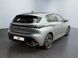 the rear of a silver car in a room with a black floor