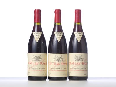 three bottles of red wine are lined up on a table