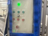 a picture of a machine in a factory with a blue cover over it