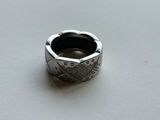 an image of a silver ring on a white surface