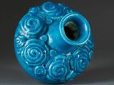 a blue vase that has a flower design on it