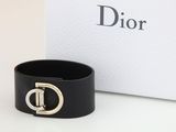 un gros plan sur un bracelet en cuir noir muni d'une boucle dorée