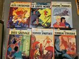 several comics are lined up on a table in a room