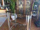 a glass table with a potted plant on top of it