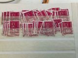 a pile of stamps on a table with a pair of scissors