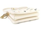 a white handbag with stars on it and a gold chain