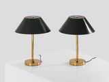a pair of black lamps sitting on top of a white table