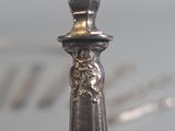 a close up of a silver spoon on top of a table