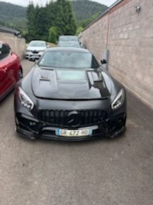 two cars parked next to each other in a parking lot