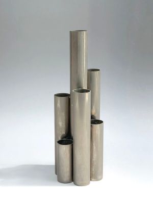 a group of four stainless steel tubes stacked on top of each other