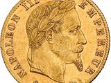 a close up of a gold coin with a man ' s head on it