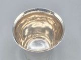a silver cup that is sitting on a table