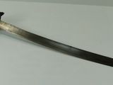 a knife that is laying on a white surface