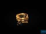 une bague sertie d'un saphir jaune sur fond noir