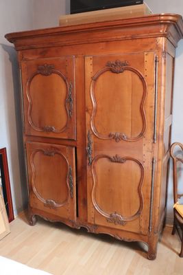 a large wooden cabinet with a tv on top of it