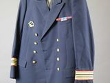 an image of a blue jacket with gold buttons and a tie on a hanger