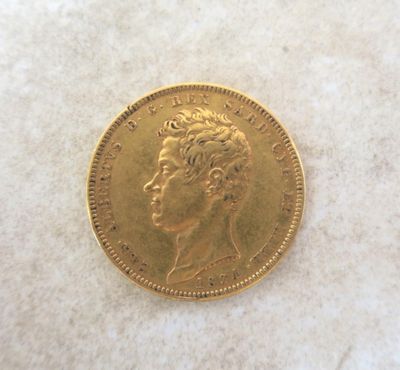 an image of a gold coin sitting on top of a white surface