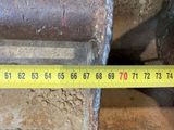 a measuring tape that is on the side of a pipe