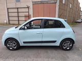 a small blue car parked in a parking lot