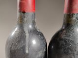 two bottles of wine sitting next to each other on a table