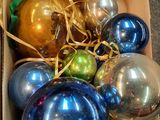 a box full of christmas ornaments sitting on the floor