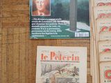 a lot of books on a table with a picture of a man