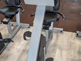 a row of stationary exercise bikes in a gym