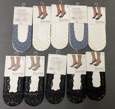 six pairs of black and white socks with polka dots on them