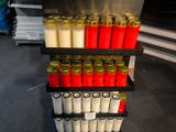 many different colored candles on the shelves in the store