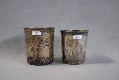 pair of silver cups with designs of birds and flowers on them