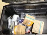 a black box filled with assorted items sitting on the floor