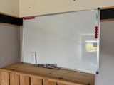 a white board on the wall in a room