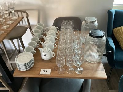a table with a lot of glasses and cups on it