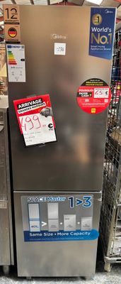 a silver refrigerator in a store with a lot of items on the shelves