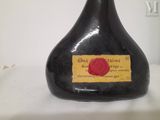 a black bottle with a red rose on the label