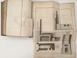 an open book with a drawing of a building on it