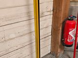 a fire extinguisher next to a fire hydrant on the sidewalk