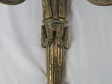 a wall sconce with a bird on it on a white sheet