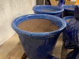 many blue vases sitting on a pallet next to each other