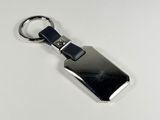 a metal keychain with a metal tag on it