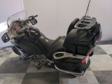 a picture of a black motorcycle parked on a checkered floor